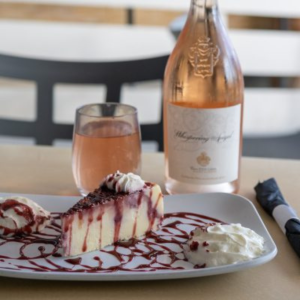 Ropewalk cheesecake beside a bottle of wine